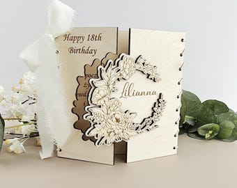 May include: A wooden card with a floral design and the text "Happy 18th Birthday" and "Lillianna".