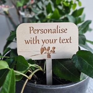 May include: A wooden plant marker with the text "Personalise with your text" and a small illustration of a potted plant with birds.