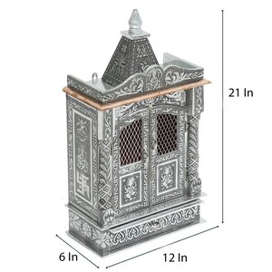 May include: A silver-colored metal temple with intricate carvings and a decorative roof. The temple has two doors and a drawer at the bottom. It measures 21 inches tall, 12 inches wide, and 6 inches deep.