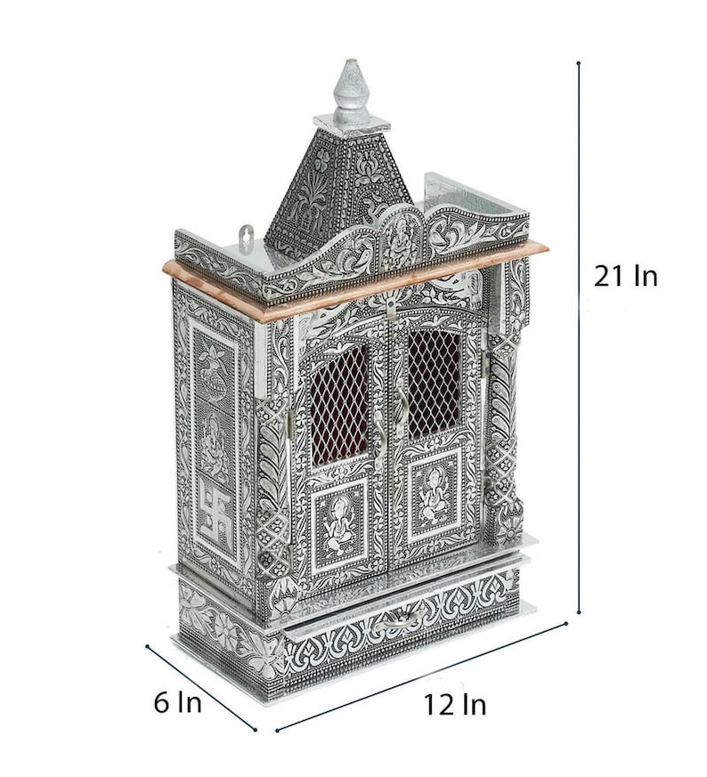 May include: A silver-colored metal temple with intricate carvings and a decorative roof. The temple has two doors and a drawer at the bottom. It measures 21 inches tall, 12 inches wide, and 6 inches deep.