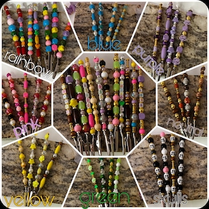 May include: A collage of beaded hair clips in various colors and designs. The clips are arranged in sections labeled "rainbow", "blue", "purple", "pink", "neutral", "yellow", "green", and "skulls". Each clip features a different bead arrangement.