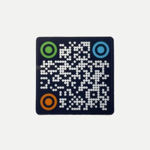 May include: A blue square sticker with a black and white QR code in the center. The QR code is surrounded by four colored circles: green, orange, blue, and red.