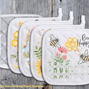 May include: Set of six white quilted pot holders with bee and honeycomb designs. The pot holders feature different bee-themed sayings, including "Bee Kind", "Bee the Change", "Bee Happy", and "Home Sweet Hive".