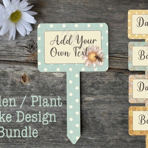 May include: A set of four garden plant stakes with a bee and daisy design. The stakes are made of wood and have a white polka dot pattern. The stakes are labeled "Daisy" and "Basil". One stake has a blank space for adding your own text.