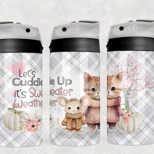 May include: Three stainless steel tumblers with a grey and white plaid pattern. The tumblers feature a variety of autumn-themed designs, including a cat and mouse wearing jumpers, a pumpkin, and a tree with pink blossoms. The tumblers have black lids and a white spout. The text on the tumblers reads "Let's Cuddle It's Sweater Weather" and "Cuddle Up Sweater Weather".