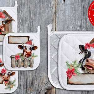 May include: Set of four white quilted pot holders with a Christmas theme. Each pot holder features a cartoon cow wearing a Santa hat and peeking out of a wooden barn. The pot holders have a red poinsettia and pine branches with pine cones.