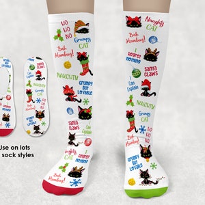May include: White Christmas-themed socks with a red and green design. The socks feature a black cat with festive accessories and text like "Naughty Cat," "Grumpy but Lovable," and "Santa Claws." The image also shows no-show socks.