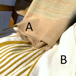 May include: Two striped blankets, one with beige and green stripes and the other with white and yellow stripes. The beige and green blanket is labeled "A" and the white and yellow blanket is labeled "B".