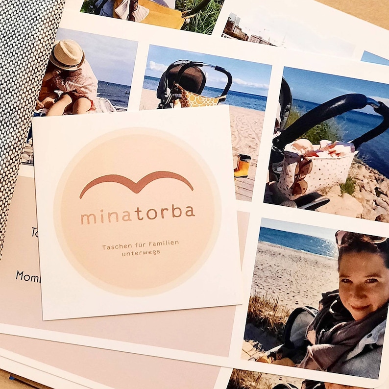 May include: A pink and white logo with a stylized bird design and the text "minatorba Taschen fur Familien unterwegs".