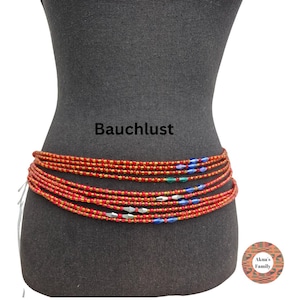 Könnte beinhalten: Rote und goldene Bauchperlen mit blauen, grünen und silbernen Akzenten sind um eine Schaufensterpuppe gewickelt. Der Text "Bauchlust" ist über den Perlen zu sehen. Ein dekoratives Accessoire.