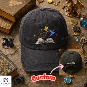 May include: A dark gray baseball cap with an embroidered design of dragons and an open book. The cap features the text "Fly or Die" on the back and an adjustable strap. A fantasy-themed accessory.