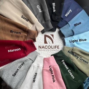 May include: A collection of crewneck sweatshirts in various colors, including sand, brown, maroon, sport gray, white, gray, black, navy, blue, light blue, military green, forest green, and light pink. The brand name "NACOLIFE" is visible.