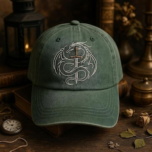 May include: A green baseball cap with a white embroidered design of a dragon wrapped around a sword. The cap has a curved brim and a fabric strap closure.
