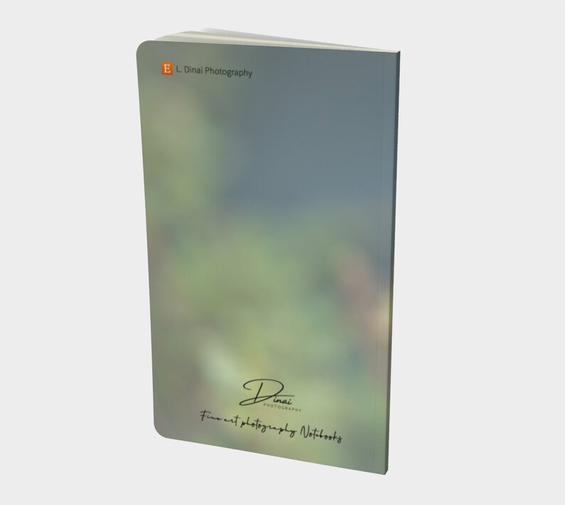 May include: A green and blue notebook with the text "E.L. Dinai Photography" and "Fine Art Photography Notebooks" on the cover.