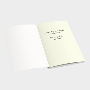 May include: An open notebook with blank pages on the left and a handwritten message on the right page. The message reads: "Here are all my secrets, thoughts, dreams and desires. Here are my self love instructions."