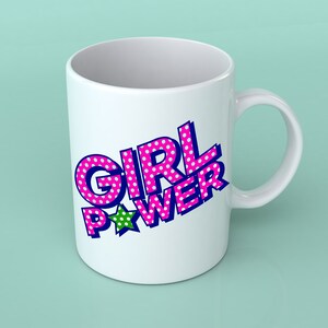 May include: White ceramic mug with a pink and blue "GIRL POWER" design with white polka dots and a green star.