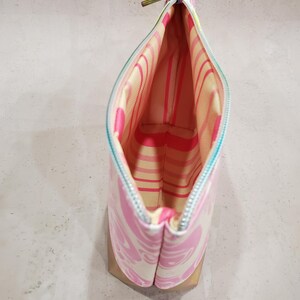 May include: A white ceramic mug with a black handle and the text "But First, Coffee" in a bold, black font. The mug is set against a blurred background, suggesting a cozy setting.