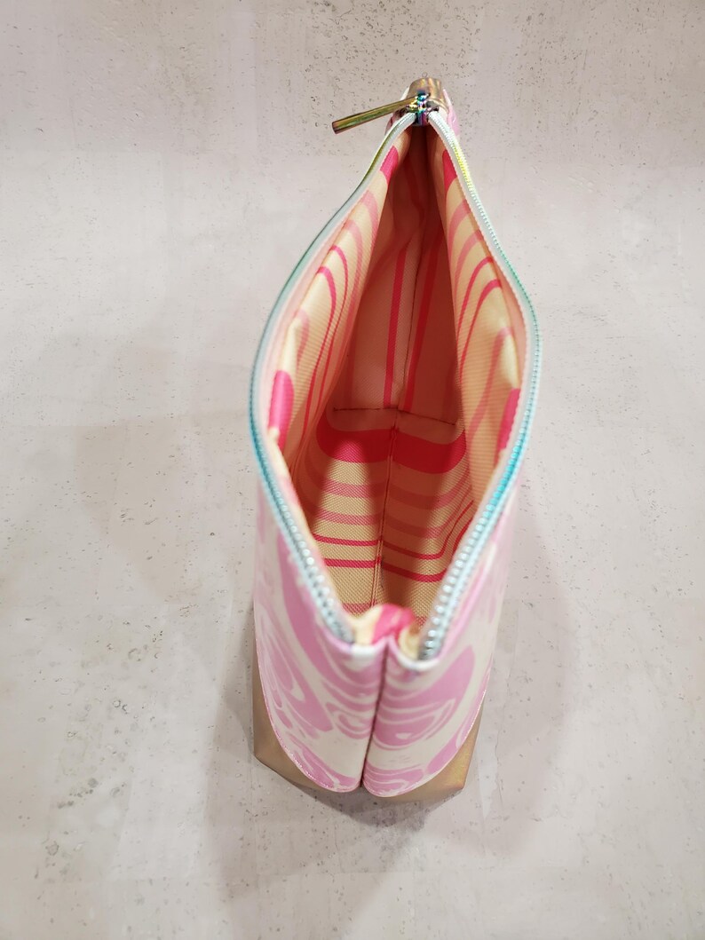 May include: A white ceramic mug with a black handle and the text "But First, Coffee" in a bold, black font. The mug is set against a blurred background, suggesting a cozy setting.