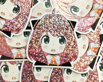 Pode incluir: Um conjunto de adesivos de glitter rosa e dourado com uma menina de desenho animado com cabelo rosa e uma faixa de cabeça com orelhas de gato. A menina está vestindo uma camisa branca com uma gravata borboleta dourada.