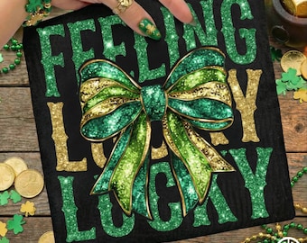 May include: Black square with the words "FEELING LUCKY" in green glitter lettering and gold glitter lettering. A large green and gold glitter bow is centered on the square. The image has a St. Patrick's Day theme.