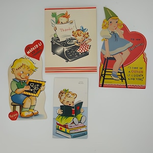 May include: Four vintage Valentine's Day cards featuring children. One card shows a boy reading a book, another shows a girl reading a book, another shows a girl typing on a typewriter, and the last card shows a girl sitting on a ladder.