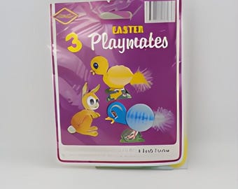 May include: A package of three Easter Playmates, featuring a yellow chick, a brown bunny, and a blue egg. Each figure has a feathery tail.
