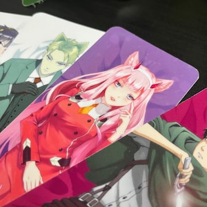 May include: A pink and red anime character with pink hair and cat ears. The character is wearing a red jacket with black accents and a yellow tie. The character is holding a finger to their cheek and looking to the side. The background is a purple gradient.