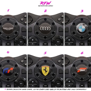 May include: Six black rotary selector knob covers featuring car brand emblems: Aston Martin, Audi, BMW, Gran Turismo, Ferrari, and Forza. The text "RFW RETROFUTURE WORKS" is at the top. The text at the bottom says "ROTARY SELECTOR KNOB COVER, L2/R2 COVER CAPS AND L3/R3 BUTTONS ARE SOLD SEPARATELY."