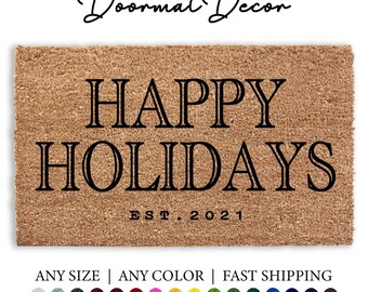 May include: A brown coir doormat with the text "HAPPY HOLIDAYS EST. 2021" in black.