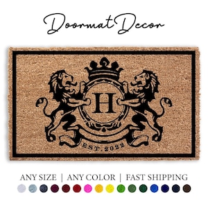 May include: A brown coir doormat with a black border and a black and white crest featuring two lions, a crown, and the letter H. The crest is surrounded by a banner with the text "EST. 2023".