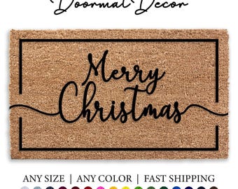 Könnte beinhalten: Eine braune Kokosmatte mit schwarzem Rand und dem Text "Merry Christmas" in einer kursivschrift.