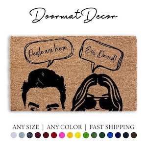 May include: A brown coir doormat with the text "People are here. Ew, David!" in black lettering. The doormat features a cartoon illustration of a man and a woman with speech bubbles above their heads.