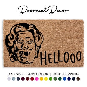 May include: A brown coir doormat with a black and white illustration of a person with a surprised expression and the text "HELLOOO" printed on the mat.