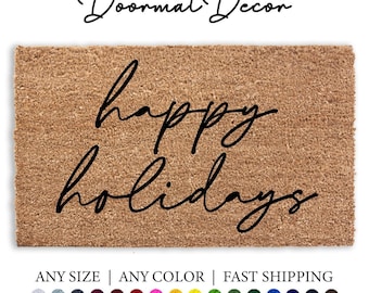 May include: A brown coir doormat with the text "happy holidays" written in black cursive script.