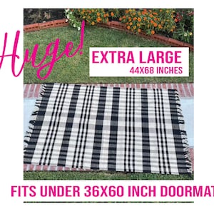 May include: Black and white plaid rug with fringe edges. The rug is extra large, measuring 44x68 inches. It fits under a 36x60 inch doormat.