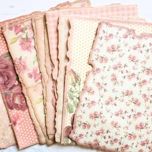 May include: A collection of decorative paper sheets featuring various vintage-inspired patterns including pink roses, floral bouquets, soft polka dots, and gingham checks, all with distressed, deckled edges in shades of cream, beige, and dusty rose.