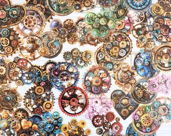 May include: A collection of assorted mechanical gears and cogs in various sizes, colors, and metallic finishes. The design features intricate circular and heart-shaped arrangements of interlocking gear components in shades of blue, gold, and copper.