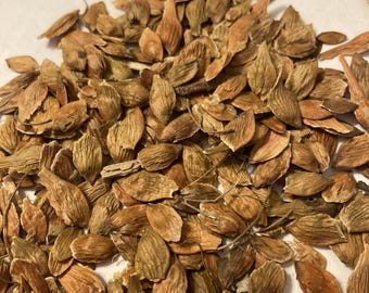 May include: A pile of light brown, dried seeds. The seeds are oval-shaped and have a slightly textured surface.