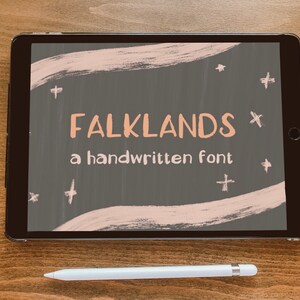 May include: A digital tablet screen displaying the text "FALKLANDS a handwritten font" in a peach colour against a dark grey background with a pink brushstroke design and white stars.