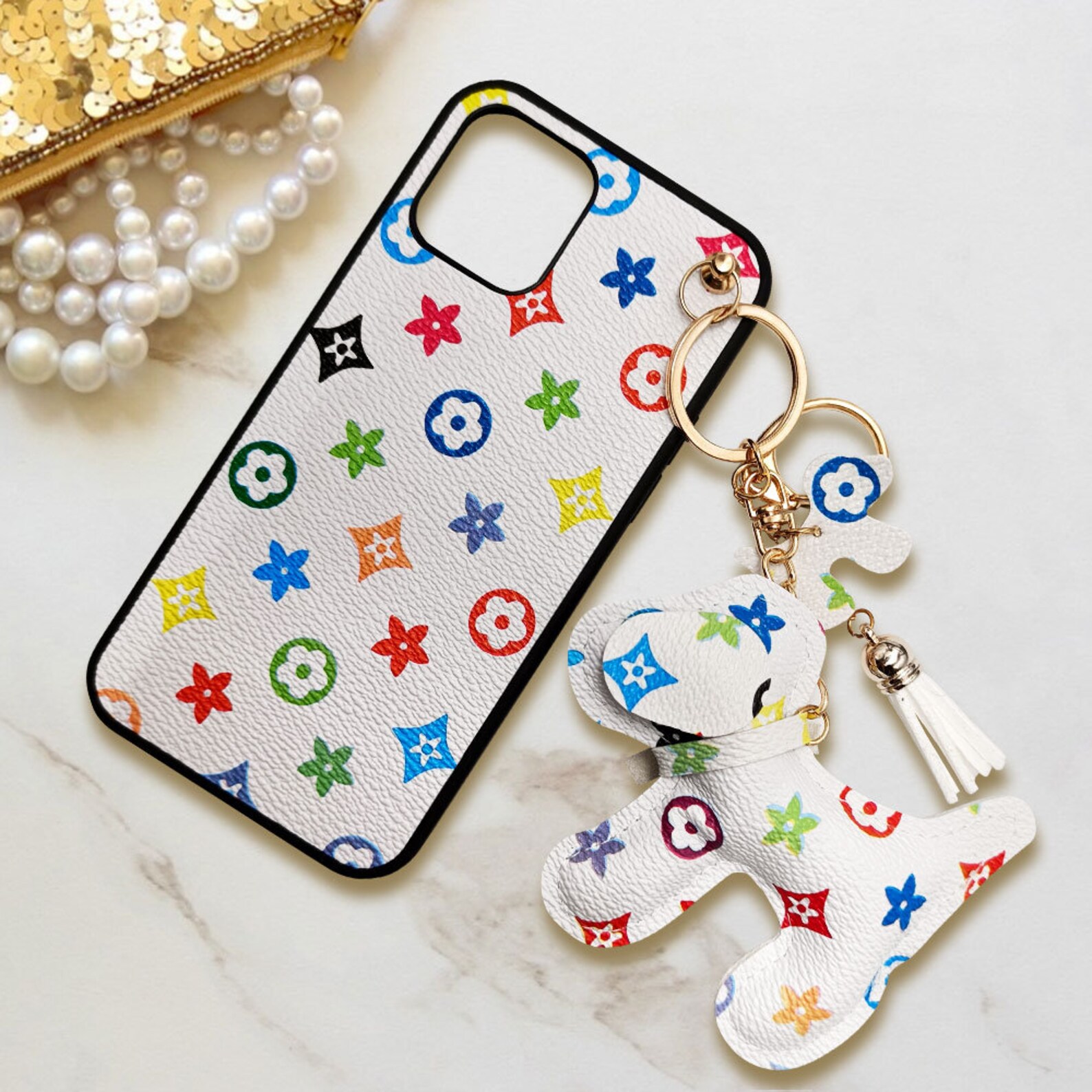 A mobile phone case with a cute puppy charm keychain suitable Etsy