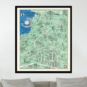May include: A framed vintage map of Rolling Hills, California, with a green background and black lines showing roads and streets. The map includes a compass rose and a key with various points of interest.