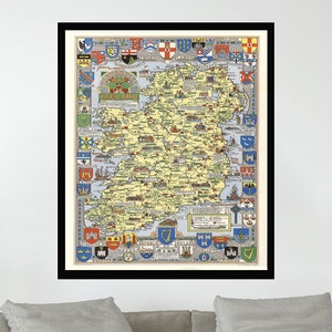 May include: A framed vintage map of Ireland, featuring detailed illustrations of counties and towns in yellow, green, and blue. The map is surrounded by colorful heraldic crests and emblems. The artwork is displayed above a gray sofa in a living room setting.