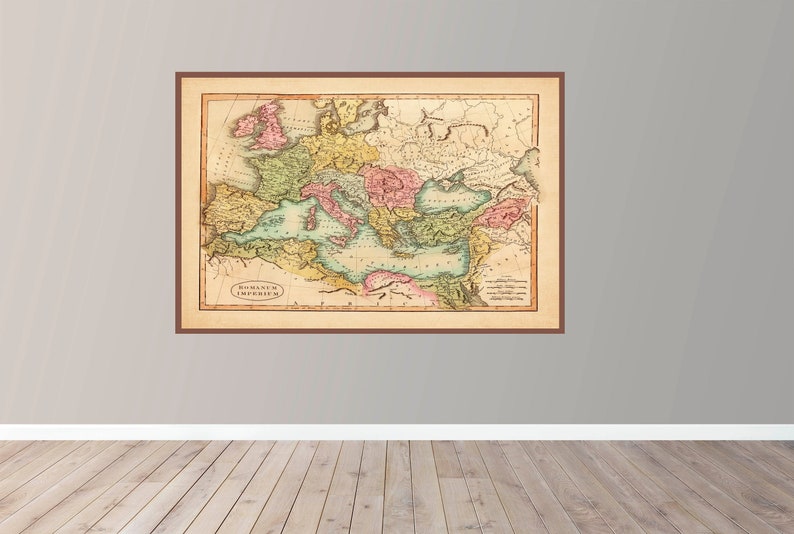 May include: An antique map of the Roman Empire, showing the borders of the empire in different colors. The map is framed in a brown frame and has a vintage look.