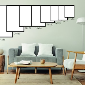 May include: A wall with a variety of black framed prints in different sizes. The prints are arranged in a row from largest to smallest. The largest print is 24x36 inches, and the smallest print is 11x14 inches. The prints are all white and have a simple, modern design.