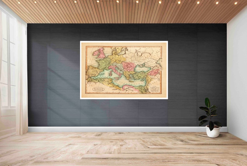 May include: A vintage map of the Roman Empire, printed on paper with a cream background. The map is framed and hanging on a dark gray wall.