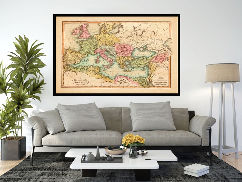 May include: A vintage map of the Roman Empire, framed in black, with a light brown background and colorful markings. The map shows the extent of the Roman Empire at its peak, with various regions and provinces highlighted in different colors.