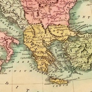 May include: An antique map of the Mediterranean region, featuring the ancient Greek and Roman empires. The map is hand-drawn and colored in shades of green, yellow, and pink. It includes the names of various cities, regions, and geographical features.