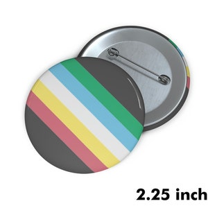 May include: A 2.25 inch button with a black background and diagonal stripes of pink, yellow, white, light blue, and green.