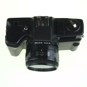 May include: A black Belka U.S.A. 35mm film camera with a lens that says "Canon Zoom Lens 35-70mm 1:3.5-5.6".