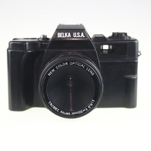 May include: A black Belka U.S.A. 35mm film camera with a New Color Optical Lens. The lens has a 1:9.3 50mm Serios 138721 inscription.